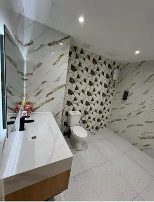a white bathroom with a toilet and a sink at Parkview Serviced Apartment in Kuala Lumpur