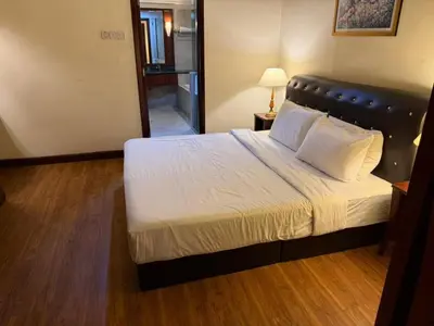 a bedroom with a large bed with white sheets and pillows at KL Suite at Times Square in Kuala Lumpur