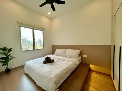 a bedroom with a bed with a hat on it at 3BR KL Sentral L27 Modern Vintage Views in Kuala Lumpur