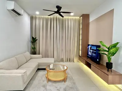 a living room with a couch and a tv at 3BR KL Sentral L27 Modern Vintage Views in Kuala Lumpur
