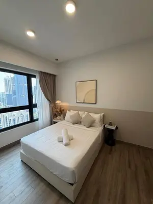 a bedroom with a large white bed and a window at Agile Landmark Suites by Kuala Lampur City in Kuala Lumpur