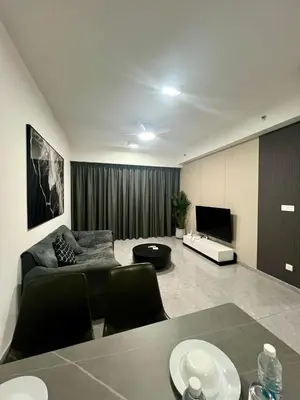 a living room with a couch and a television at Agile Landmark Suites by Kuala Lampur City in Kuala Lumpur