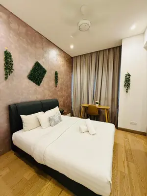 a bedroom with a large bed with white sheets at Lucentia Residence Skyline KL Stay in Kuala Lumpur