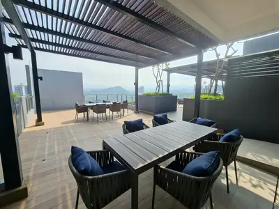a patio with a wooden table and chairs with a view at Small Studio Neu Suites Gleneagles Ampang KL in Kuala Lumpur