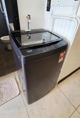 a washing machine with a sink in a room at Chillax Studio Near KLCC Gleneagles in Kuala Lumpur