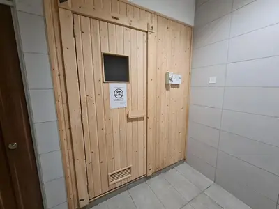 a wooden door with a sign on it in a room at Little Studio Neu Suites near KLCC in Kuala Lumpur