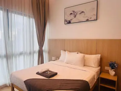 a hotel room with a bed with a suitcase on it at The Luxe & Colony KLCC By Downtown Suites in Kuala Lumpur