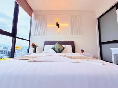 a bedroom with a large bed with a large window at Scarletz Luxury Suites KL in Kuala Lumpur