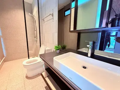 a bathroom with a white sink and a toilet at Scarletz Luxury Suites KL in Kuala Lumpur