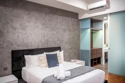 a bedroom with a large bed and a wall at Novo Ampang Residence Studio Close to KLCC and Gleneagles in Kuala Lumpur