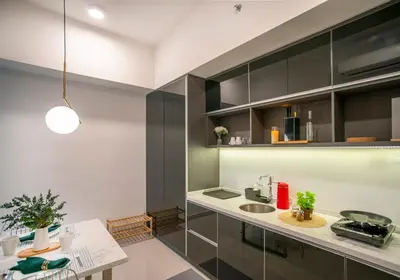 a kitchen with black cabinets and a white counter top at Novo Ampang Residence Studio Close to KLCC and Gleneagles in Kuala Lumpur