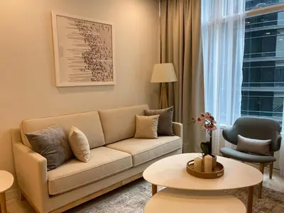 a living room with a couch and a table at Scarletz Suites KLCC by ENBA in Kuala Lumpur