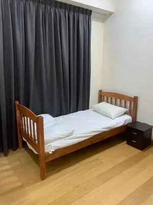 a wooden bed in a room with a black curtain at Scarletz Suites KLCC by ENBA in Kuala Lumpur