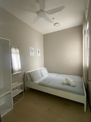 a bedroom with a bed with a ceiling fan at Comfort Stay Neusuite Jelatek in Kuala Lumpur