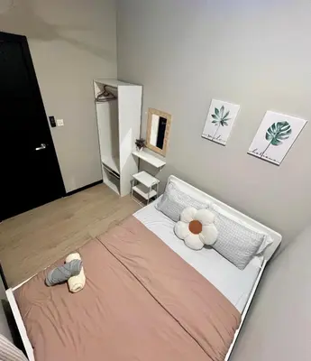 a bedroom with a bed with a flower on it at Comfort Stay Neusuite Jelatek in Kuala Lumpur