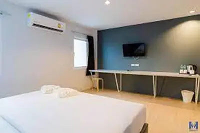 a bedroom with a white bed and a tv at Lofts At Hang Kasturi Kuala Lumpur in Kuala Lumpur