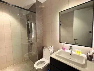 a bathroom with a sink and a toilet and a mirror at The Axon Residence KLCC Suites Kuala Lumpur in Kuala Lumpur