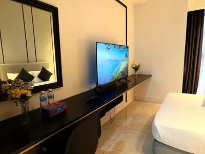 a bedroom with a flat screen tv on a desk at The Axon Residence KLCC Suites Kuala Lumpur in Kuala Lumpur