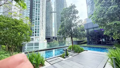 a swimming pool in a city with tall buildings at Star Residences Apartment KLCC in Kuala Lumpur