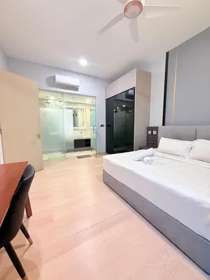a bedroom with a bed and a table and a desk at Star Residences Apartment KLCC in Kuala Lumpur
