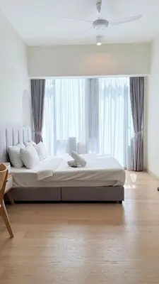 a bedroom with a large bed with a large window at Star Residences Apartment KLCC in Kuala Lumpur