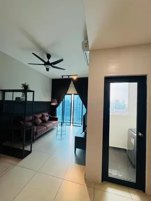 a living room with a ceiling fan and a couch at Reizz Residence by Ampang Kiri in Kuala Lumpur