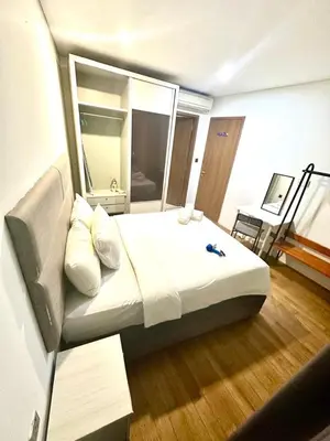 a bedroom with a large bed with a mirror at Vortex suites klcc 8pax with City views in Kuala Lumpur