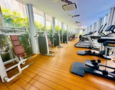 a gym with a row of treadmills and machines at Vortex suites klcc 8pax with City views in Kuala Lumpur
