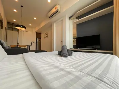a large white bed with two stuffed animals on it at The Robertson Bukit Bintang by TALKS COLLECTION in Kuala Lumpur