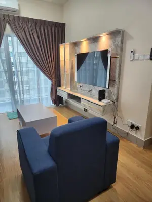 a living room with a blue chair and a tv at RC Balqis Homestay in Kuala Lumpur