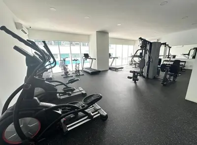 a gym with several treadmills and machines in it at RC Balqis Homestay in Kuala Lumpur