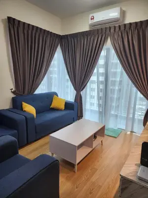 a living room with a blue couch and a table at RC Balqis Homestay in Kuala Lumpur