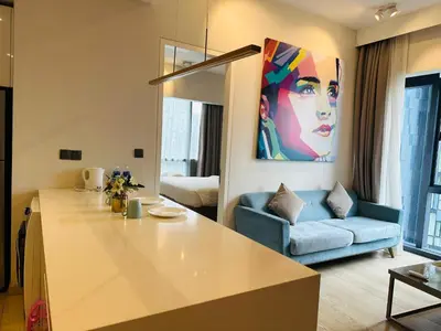 a kitchen and living room with a blue couch at Astra Suites - Star Residence KL in Kuala Lumpur