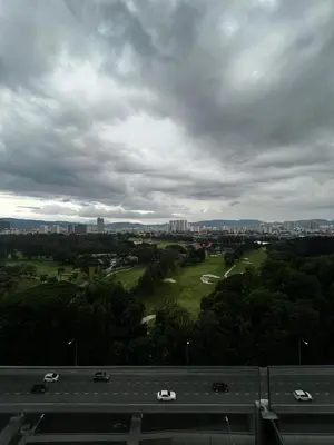 a view of a highway and a golf course with cars at Stylish City Hideout - Comfy Sofa, Warm Ambience in Kuala Lumpur