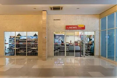 a store with glass doors in a building at Stylish City Hideout - Comfy Sofa, Warm Ambience in Kuala Lumpur