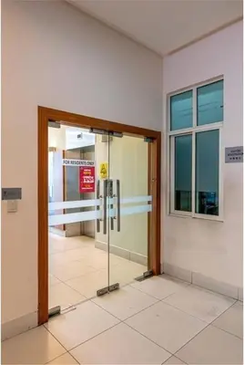 an entrance to a building with a revolving door at Stylish City Hideout - Comfy Sofa, Warm Ambience in Kuala Lumpur