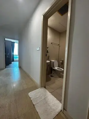 an empty bathroom with a toilet and a doorway at Stylish City Hideout - Comfy Sofa, Warm Ambience in Kuala Lumpur