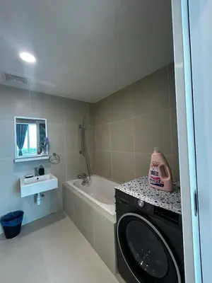 a bathroom with a washing machine and a bath tub at Stylish City Hideout - Comfy Sofa, Warm Ambience in Kuala Lumpur