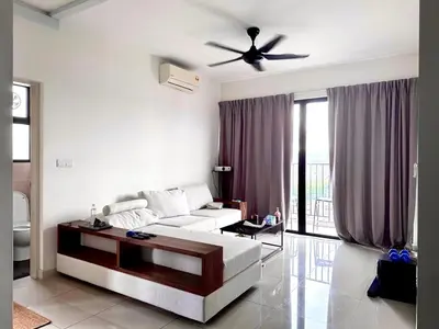 a living room with a white couch and a ceiling fan at Tuan Residency in Kuala Lumpur
