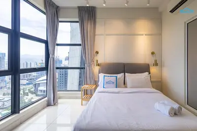 a bedroom with a large bed and large windows at Arte Mont Kiara Luxe Suites by Dream'Inn in Kuala Lumpur