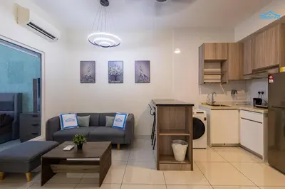 a living room with a couch and a kitchen at Arte Mont Kiara Luxe Suites by Dream'Inn in Kuala Lumpur
