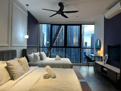 a bedroom with two beds and a ceiling fan at Scarletz Suites KLCC Studio in Kuala Lumpur