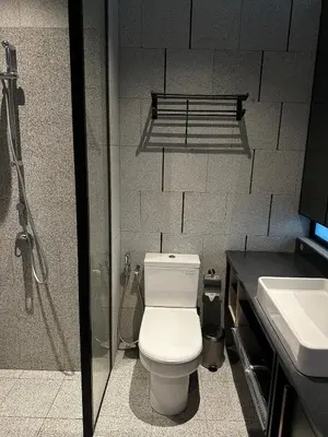 a bathroom with a toilet and a shower and a sink at Scarletz Suites KLCC Studio in Kuala Lumpur