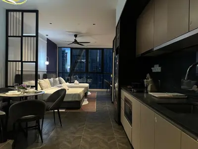 a kitchen and living room with a bed and a table at Scarletz Suites KLCC Studio in Kuala Lumpur