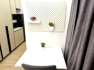 a white table and a chair in a room at The Luxe Infinity Skypool By Tasu Homes in Kuala Lumpur