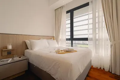 a bedroom with a large white bed with a window at Novo Ampang 2 Bedrooms KLCC view in Kuala Lumpur
