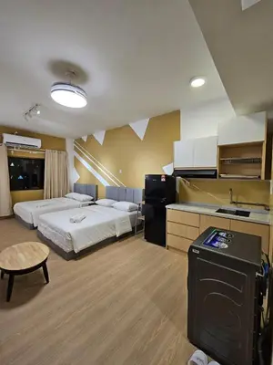 a hotel room with two beds and a kitchen at CEMPAKA SUITES By VG Homes in Kuala Lumpur