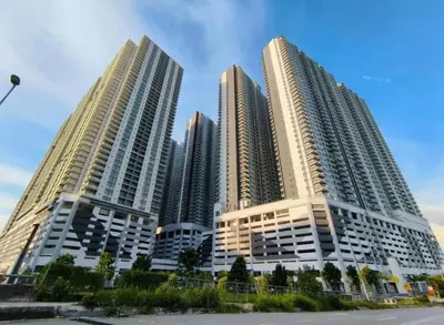 three tall buildings in front of a city at ESU Home Ventures in Kuala Lumpur
