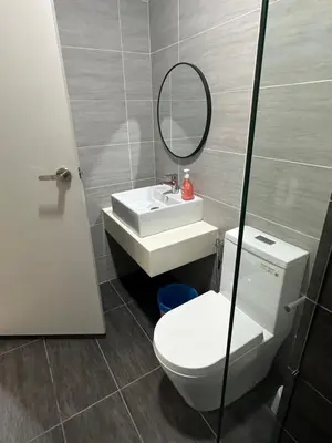 a bathroom with a toilet and a sink and a mirror at Trion Dream house KL City in Kuala Lumpur