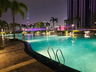 a large swimming pool in a city at night at Trion Dream house KL City in Kuala Lumpur